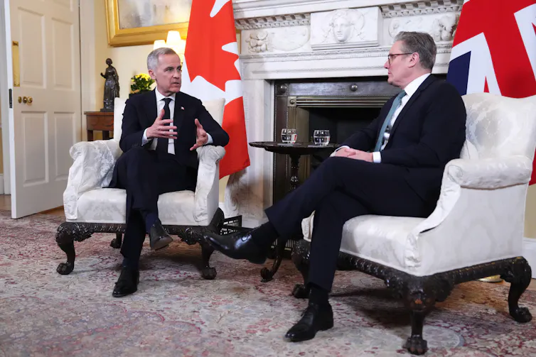 Mark Carney and Keir Starmer sitting in armchairs, talking.