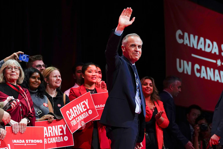 Mark Carney waving to fans.
