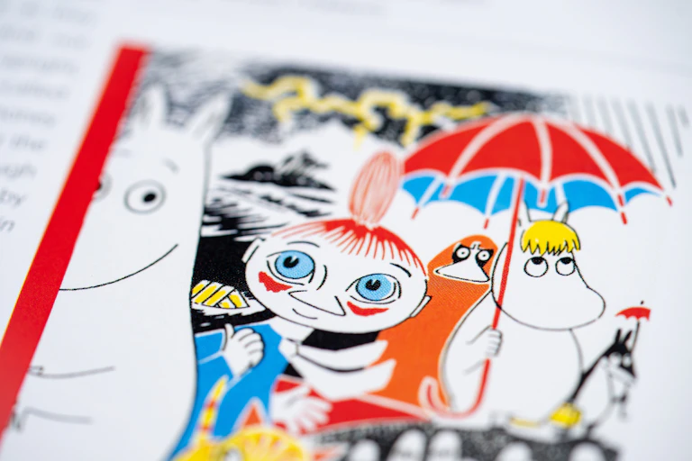 A close up of a colourful Moomins illustration.