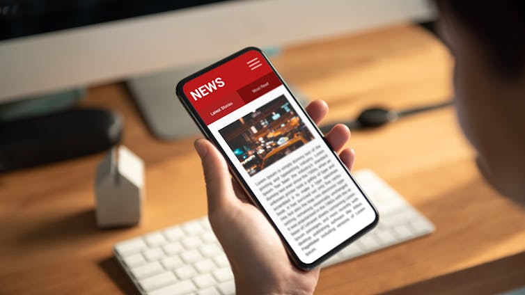 person's hand holding a mobile phone