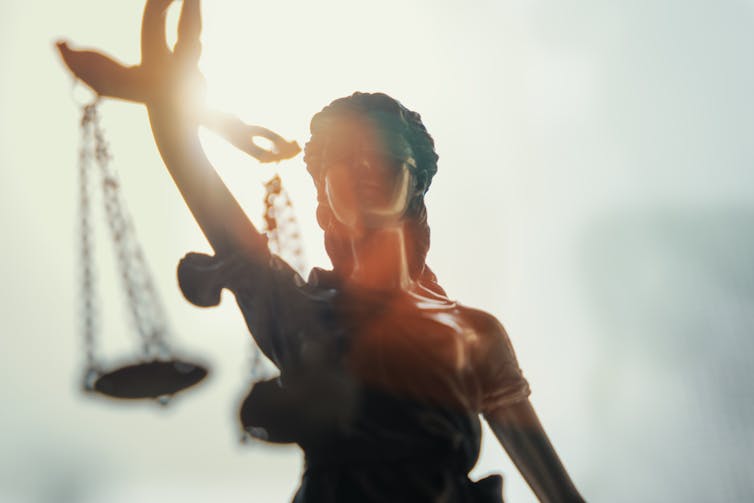backlit closeup of lady justice statue
