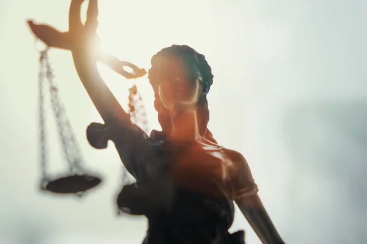 backlit closeup of lady justice statue