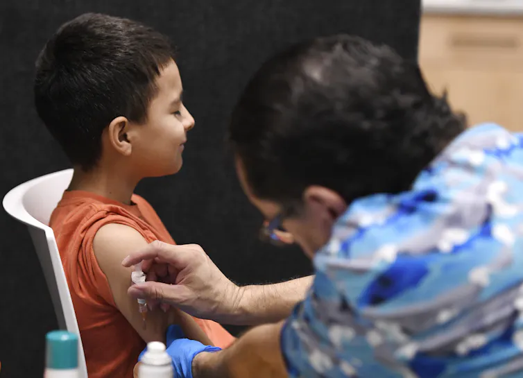 A boy receives a vaccination.