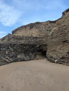 coastal cliffs, sandy beach, blue sky