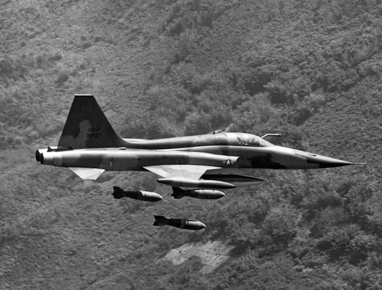 A plane drops bombs.