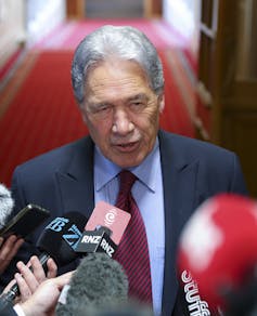 Winston Peters talking to media in parliament hallway