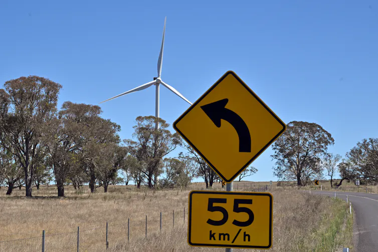 A wind turbine with 55km per hour speed sign.