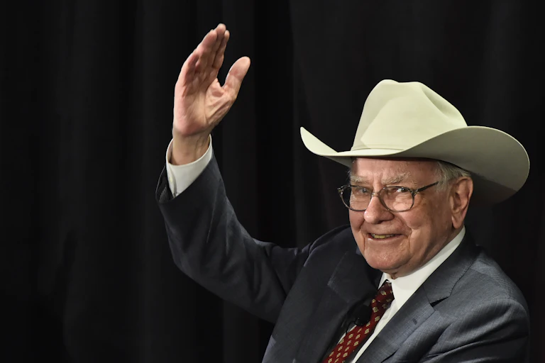 Berkshire Hathaway CEO Warren Buffett waves