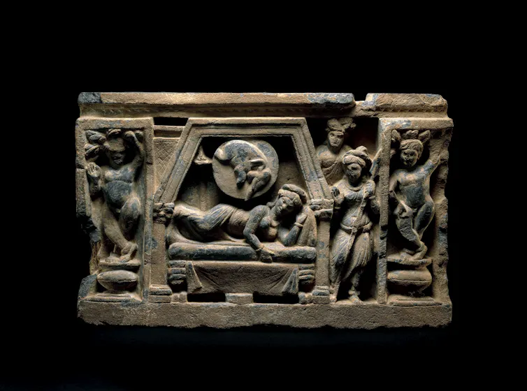 A drum panel showing a woman lying on her side and an elephant next to her. Several others stand around her, likely as guards.