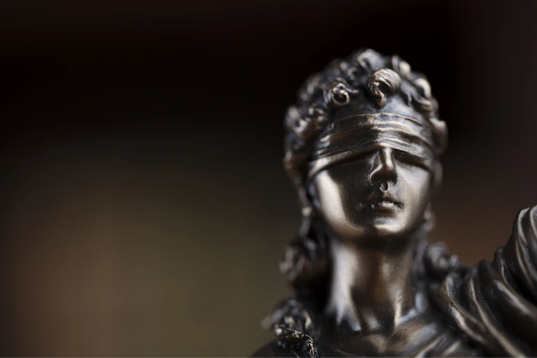 A blindfolded image of Justice.