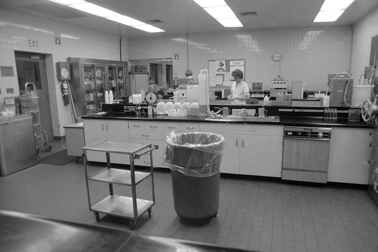 Grayscale photo of workers in milk processing area of Hillfarm Dairy
