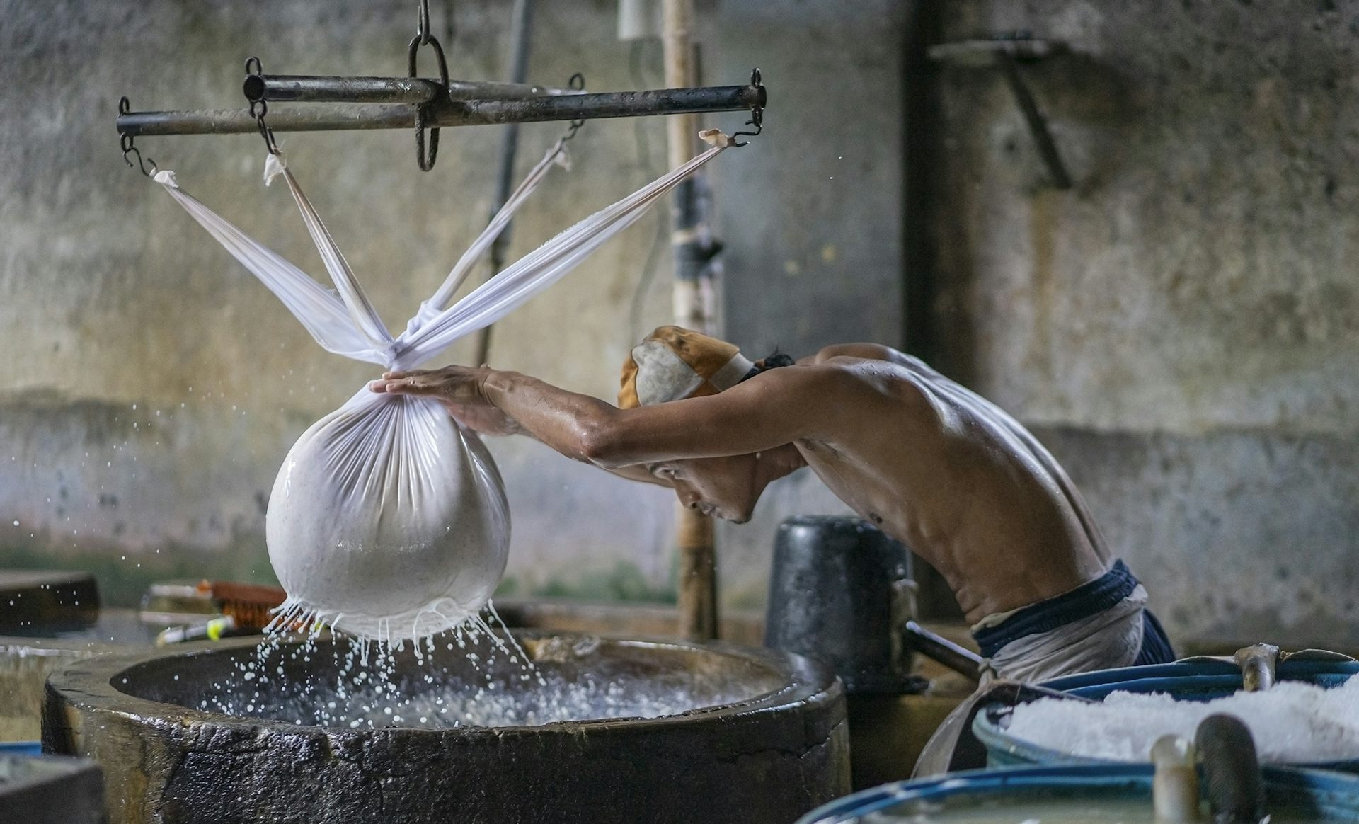 Un ouvrier presse le soja pour en extraire l’eau, dans le village de Krian (Sidoarjo), dans l'est de Java, connu pour ses usines de fabrication de tofu.