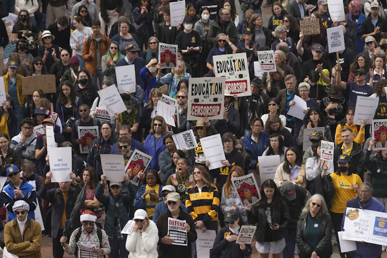 A rally of people, some with signs saying education not censorship.