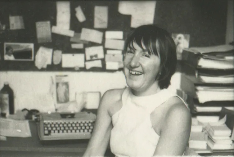 Beatrice laughing in her office.
