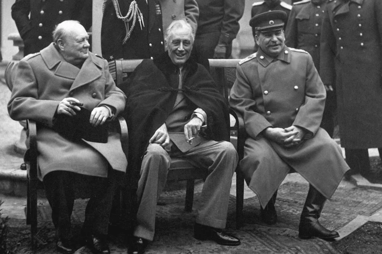 British Prime Minister Winston Churchill, U.S. President Franklin Roosevelt, and Soviet leader Joseph Stalin sit together during the Yalta conference in February 1945