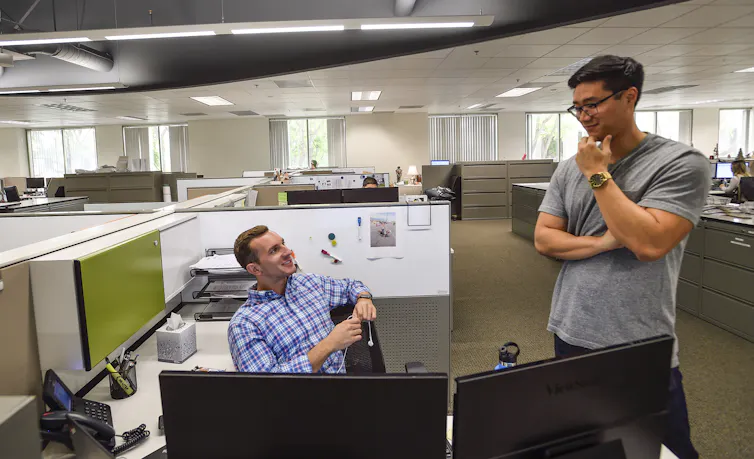 Two men have a conversation.