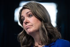 A woman with dark hair and a skeptical expression on her face. A woman with dark hair and a skeptical expression on her face.