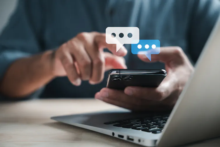 Close-up of a person's hands holding a smartphone. speech bubbles appear above