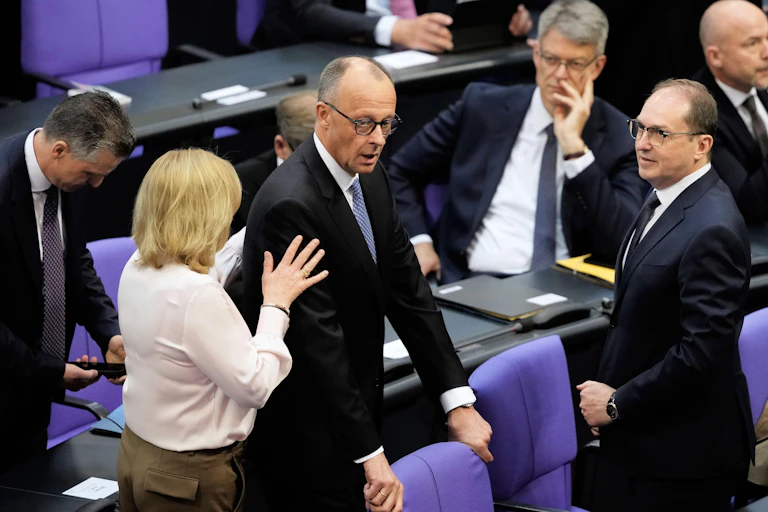 Friedrich Merz in parliament, surrounded by his MPs.