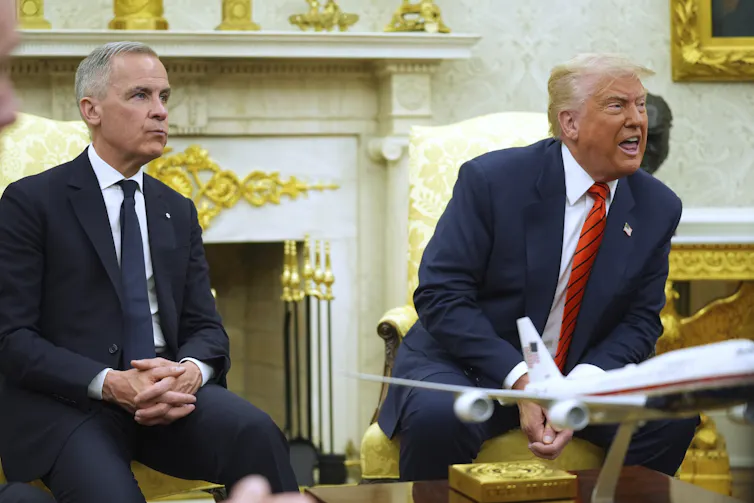A man with short grey hair sits next to a rotund man with fluffy white-blond hair who's sneering as he answers reporters who are not seen in the photos.
