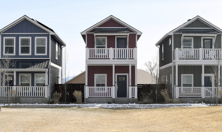 Three detached houses sitting side by side