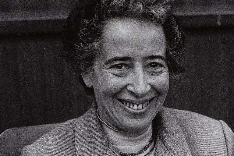 A woman smiling in a suit.
