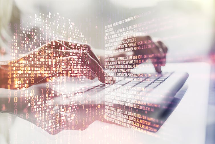 Hands on a keyboard with many digits suggesting digital transfer are floating around.