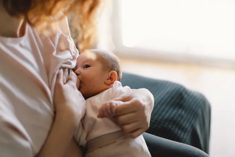 A woman breastfeeding a baby.