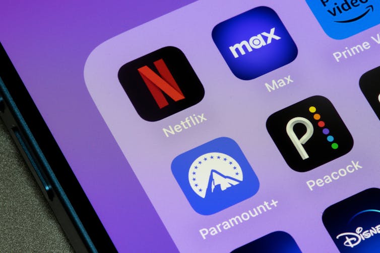 App icons on a phone for Netflix, Max, Paramount+ and Peacock