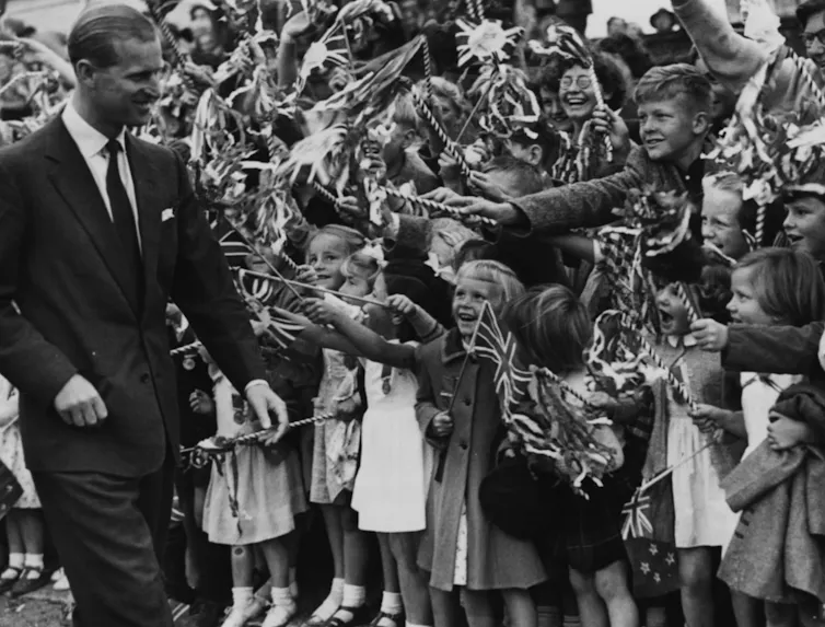 Children waving Union Jack flags at the Duke of Edinburgh in 1953/54
