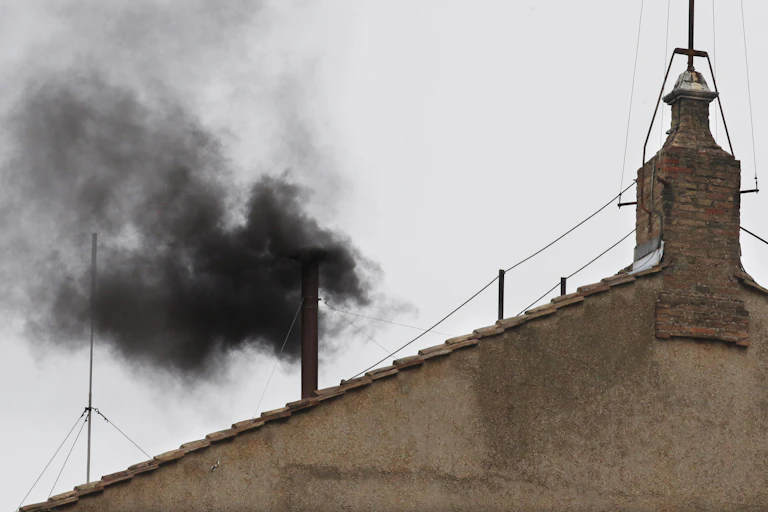 A rooftop and black smoke.