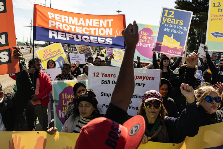 A crowd of people with protest banners