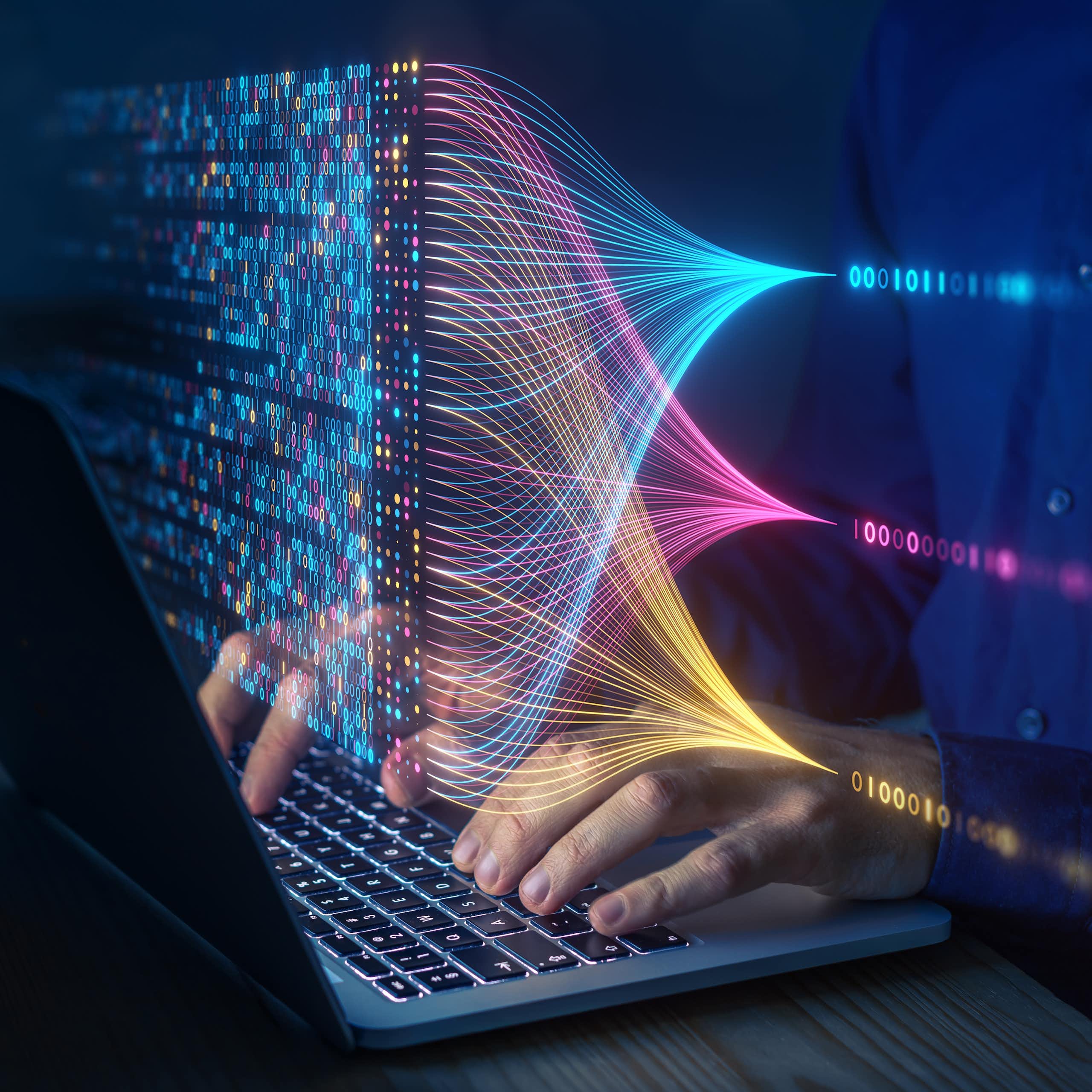 A person in a blue shirt is typing on a laptop with an illustration of blue, yellow and pink lines, as well as zeroes and ones, hovering above the keyboard.