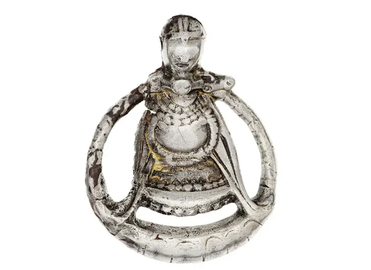 A silver pendant showing a pregnant woman