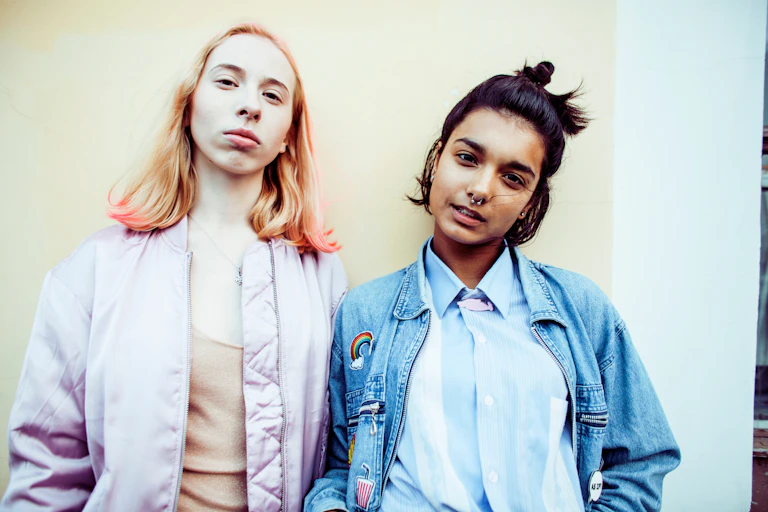Two teen girls look at camera
