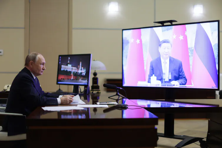 Russian president Vladmir Putin talks with Chinese president Xi Jinping over video link from the Kremlin.