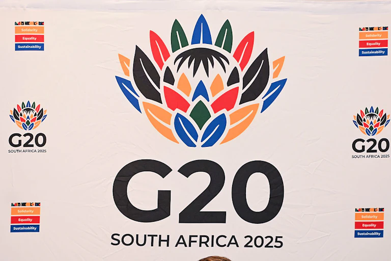 G20 South Africa 2025 logo with graphic of protea flower in the colours of the South African flag