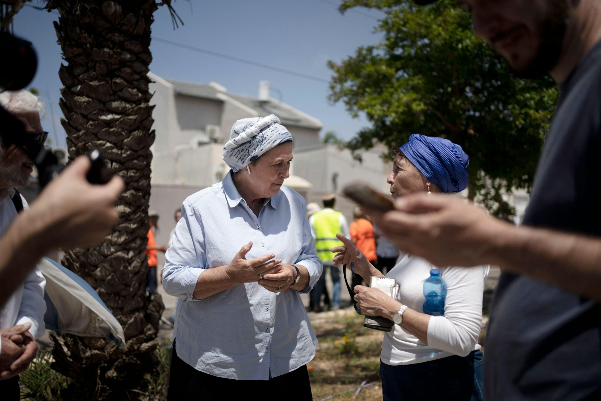 Daniella Weiss, an elderly Israeli woman, talks with another woman at a rally near Gaza.