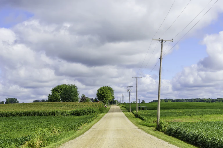 An unpaved road in rural Indiana leads to the horizon.