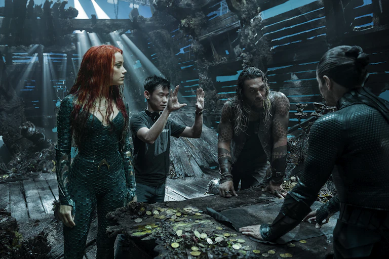 Amber Heard, director James Wan and Jason Momoa filming a scene.