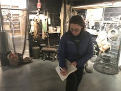 Anna Turns with notepad in fishing heritage exhibition