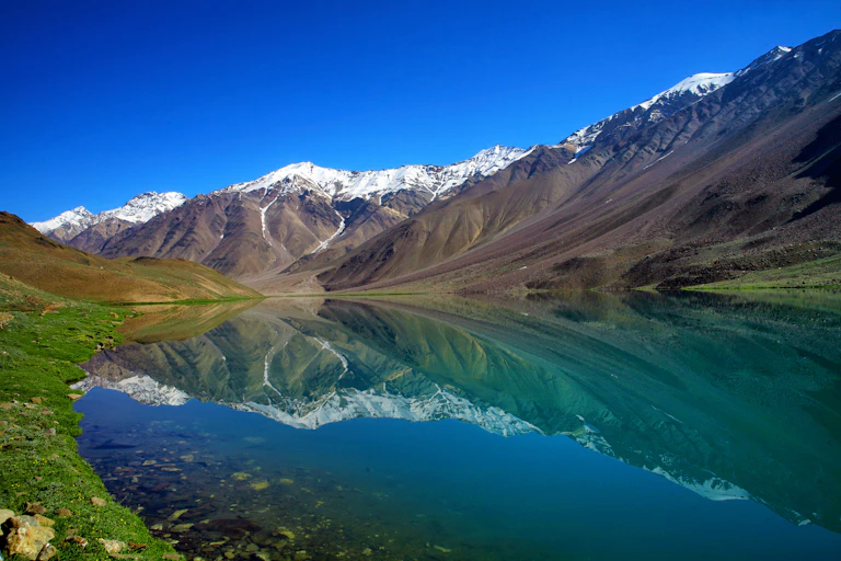 Mountains reflect on surface of lake