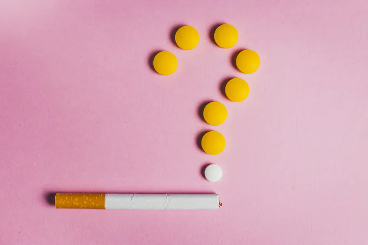Cigarette with round pills arranged above it in the shape of a question mark