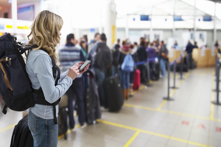 Travellers queuing at airport