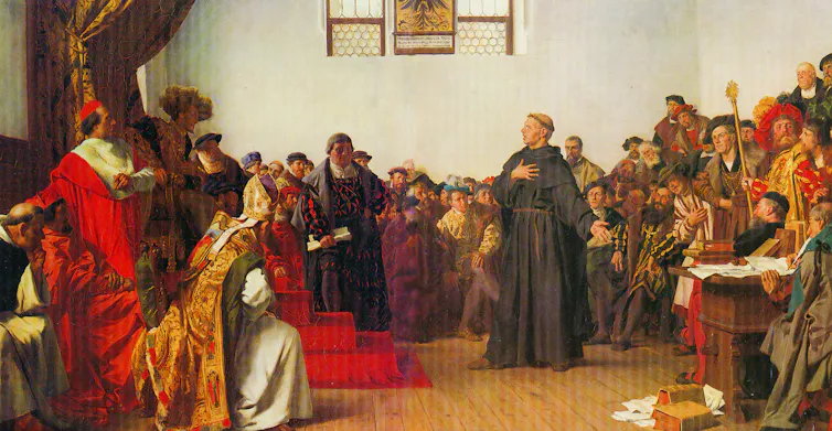Oil painting: Luther stands proud in a unhappy crowd.