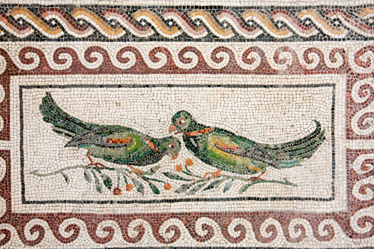 A mosiac featuring two green parrots.