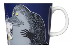 A mug with a strange, sad-looking humpbacked creature on it.