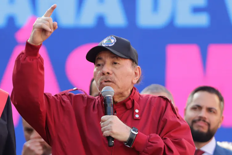 Daniel Ortega wearing a cap speaks during an event in Caracas.