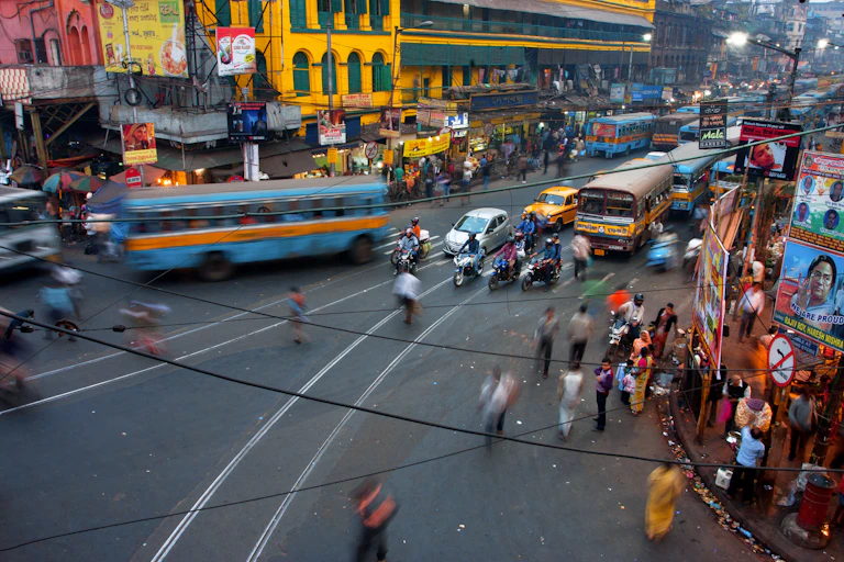 busy kolkata street scene with cars, buses and pedestrians