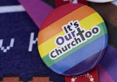 A rainbow pin says it's our church too.